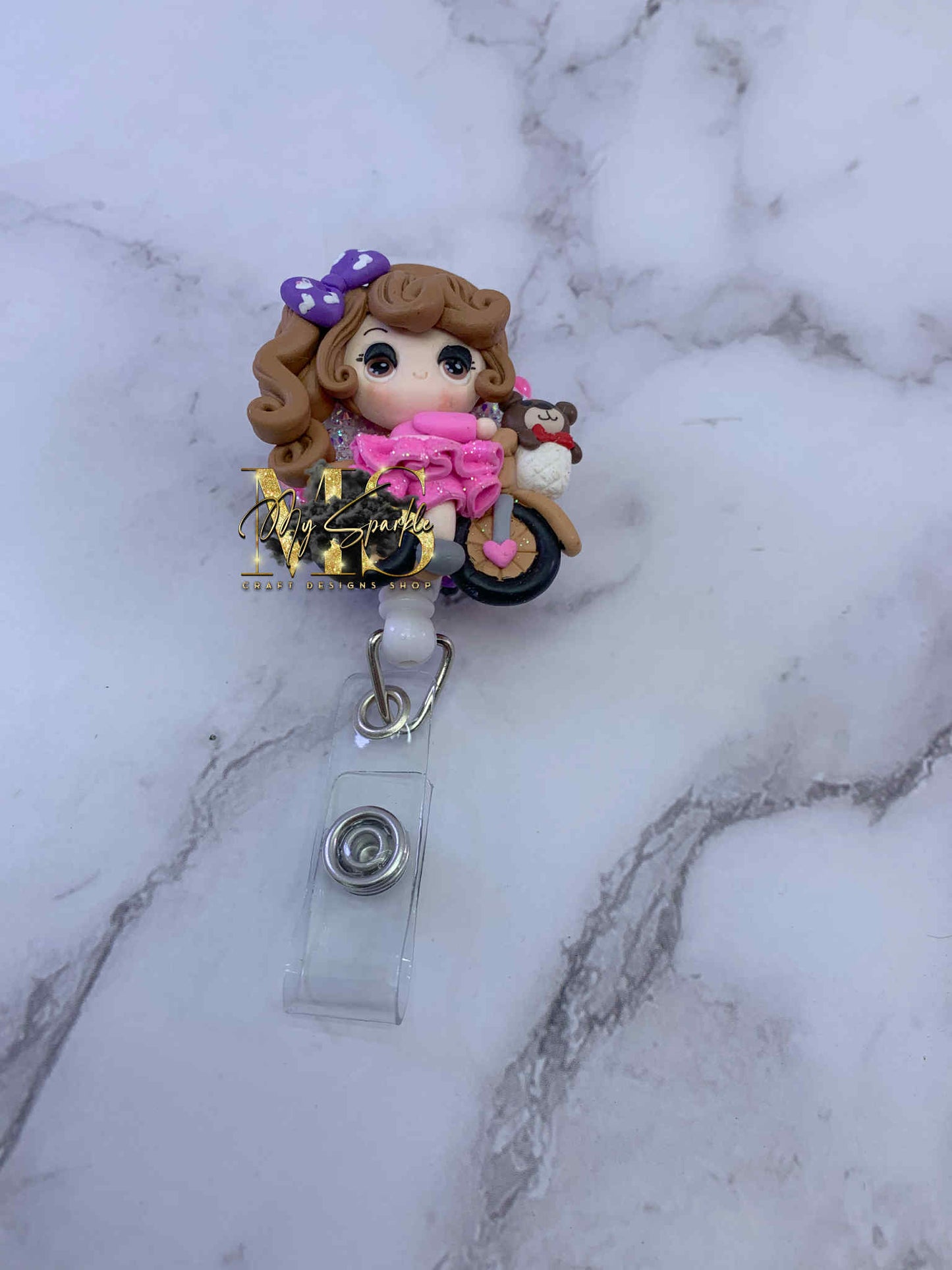 Girl Riding Bike Clay Badge Reel
