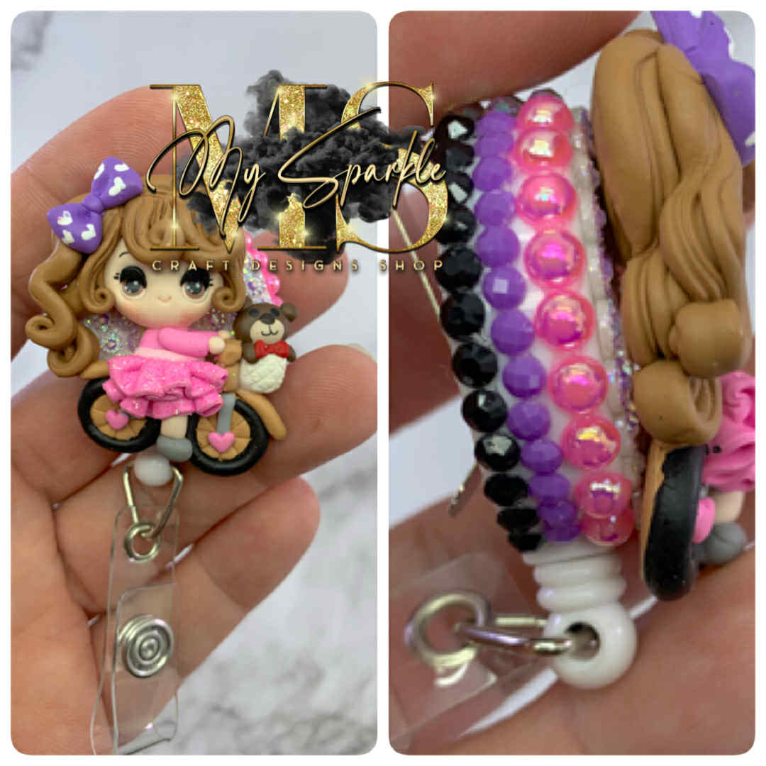 Girl Riding Bike Clay Badge Reel
