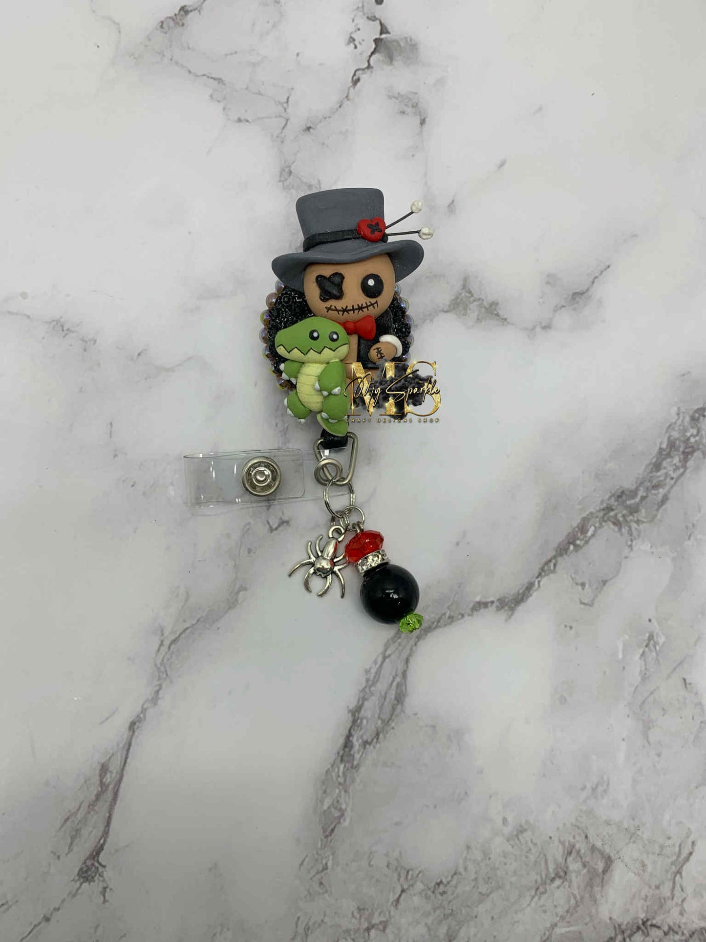 Voodoo Doctor Doll Clay Badge Reel