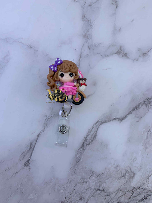 Girl Riding Bike Clay Badge Reel